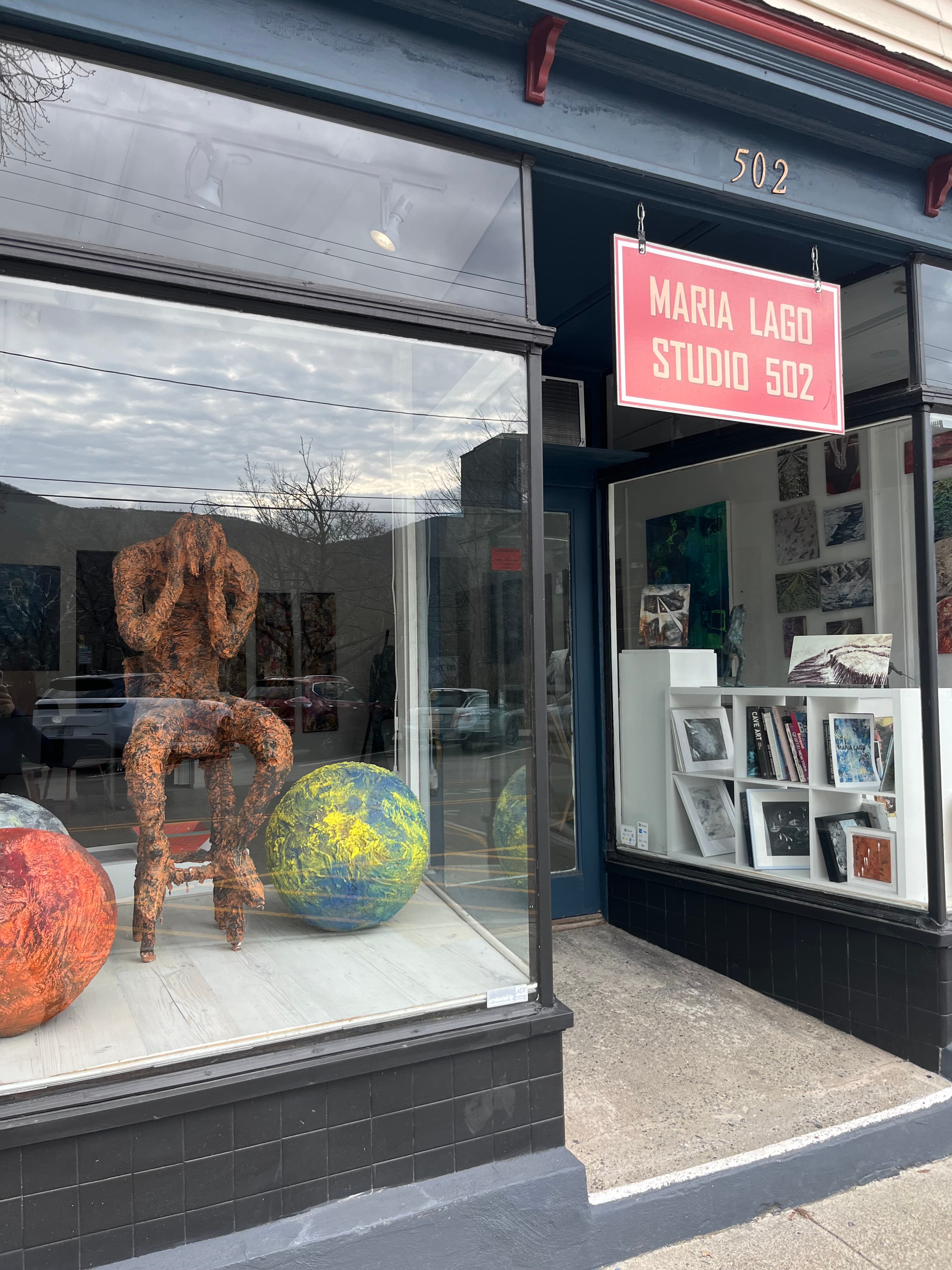 Exterior of Maria Lago Studio 502 featuring a sculpture and colorful spheres in the window.